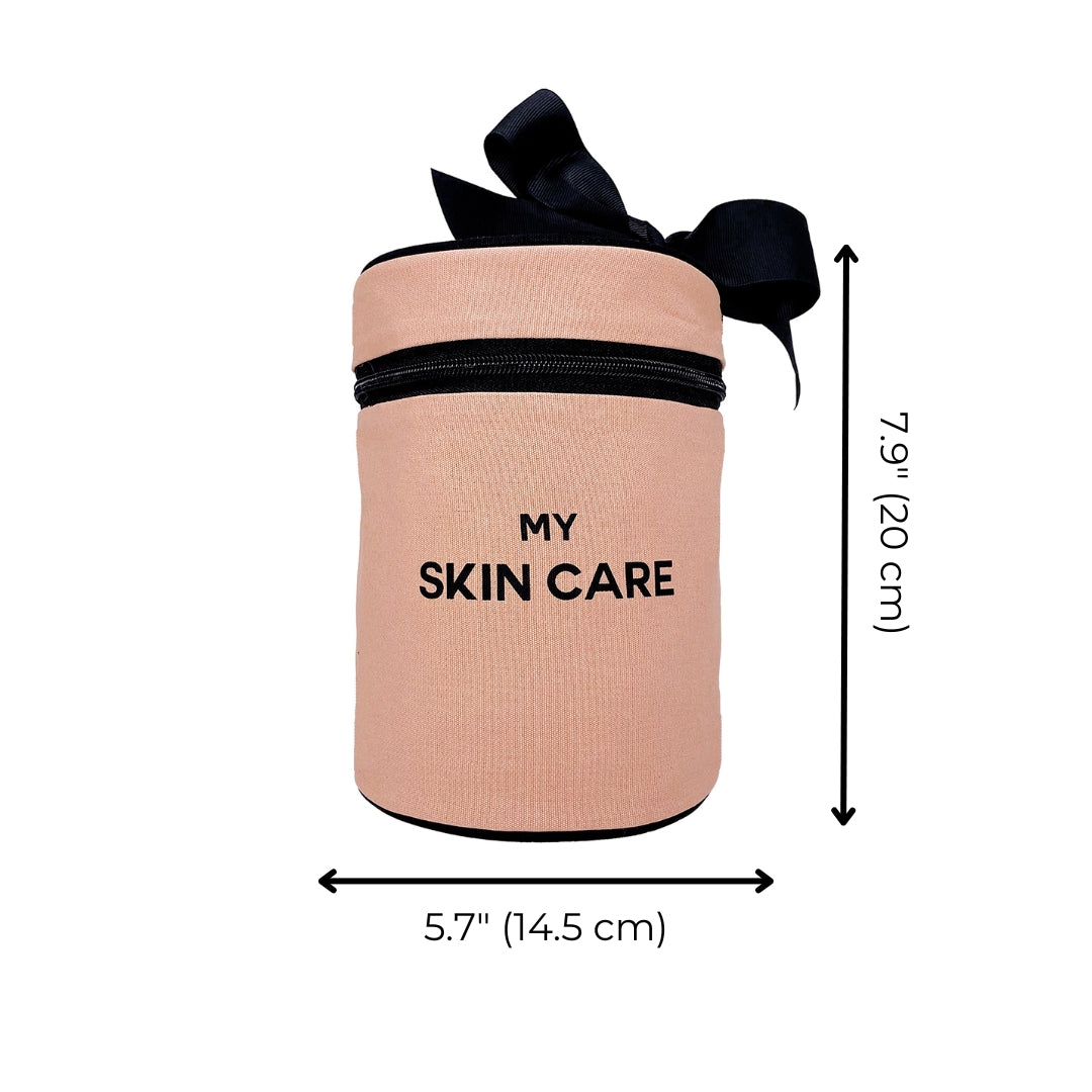 Bag-all Round Skin Care Case with Handle in blush pink featuring black bow accent, zipper closure, and "MY SKIN CARE" text, measuring 7.9 x 5.7 inches