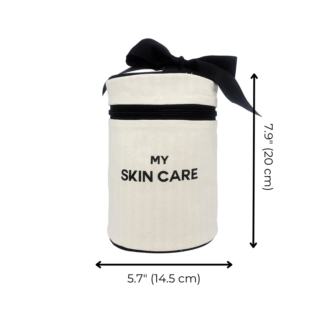 Bag-all Round Skin Care Case with Handle in cream cotton canvas, featuring black bow, zipper closure and MY SKIN CARE text, measuring 7.9 x 5.7 inches