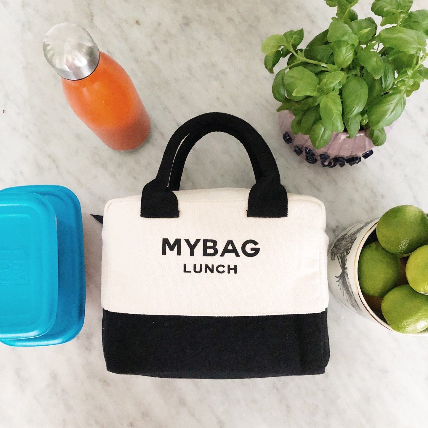 Bag-all Lunch Box Insulated in cream and black cotton fabric with soft handle and metal zipper, perfect for keeping food warm and drinks cold. Stylish insulated lunch bag for work and school.