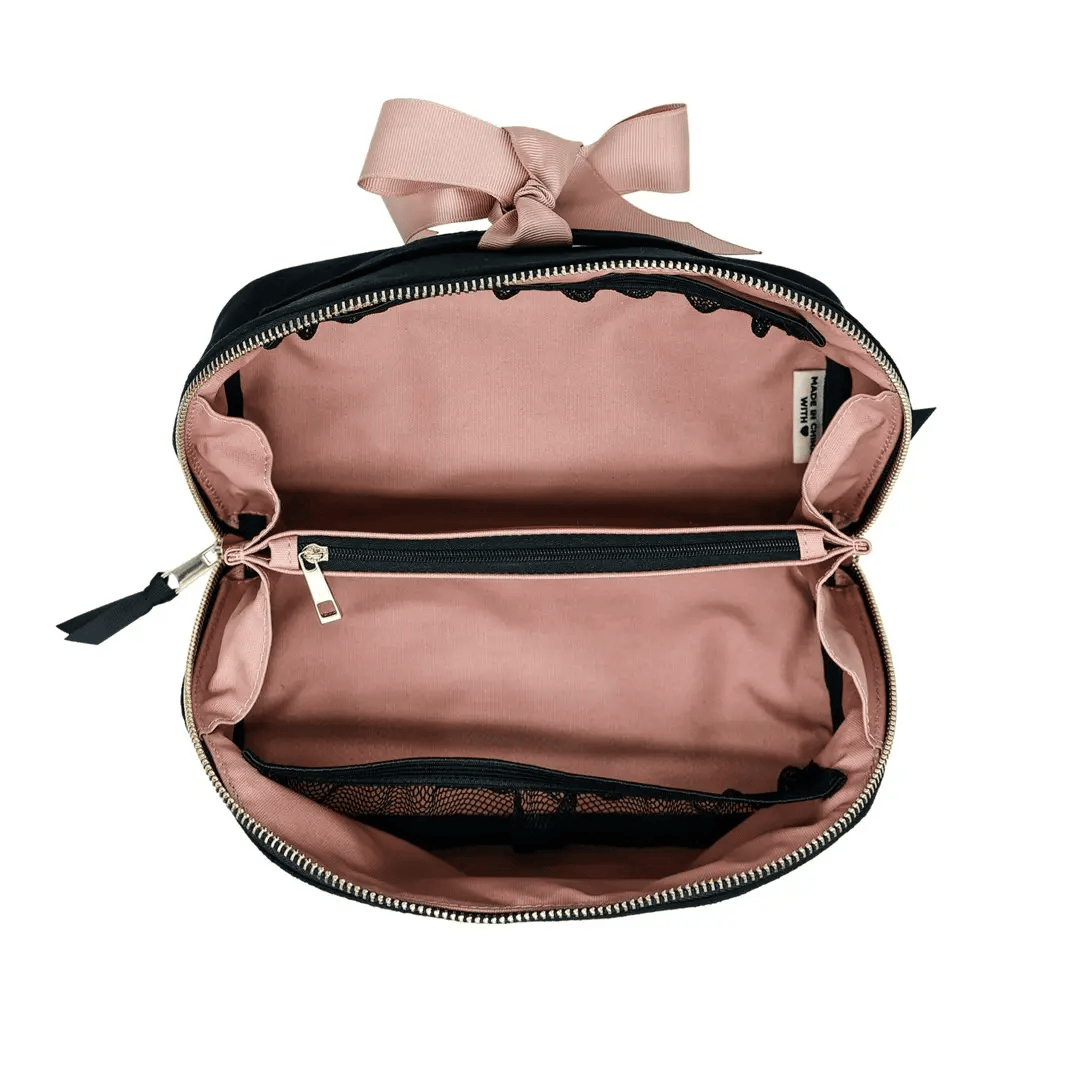 Bag-all expandable black velvet makeup bag with pink interior and zippered compartments for organized beauty storage