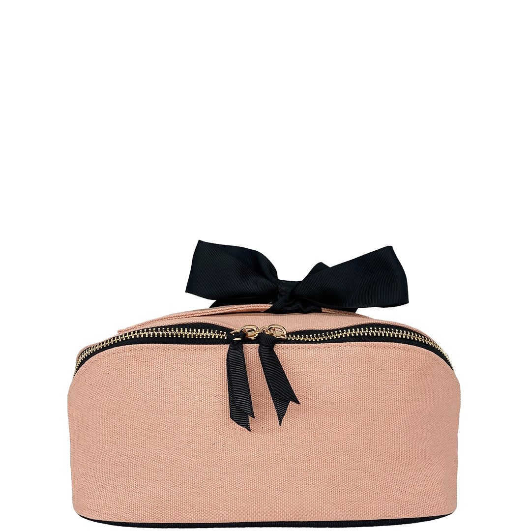 Bag-all Makeup Case in nude pink cotton canvas with elegant black bow, featuring gold zipper details - perfect for beauty essentials storage