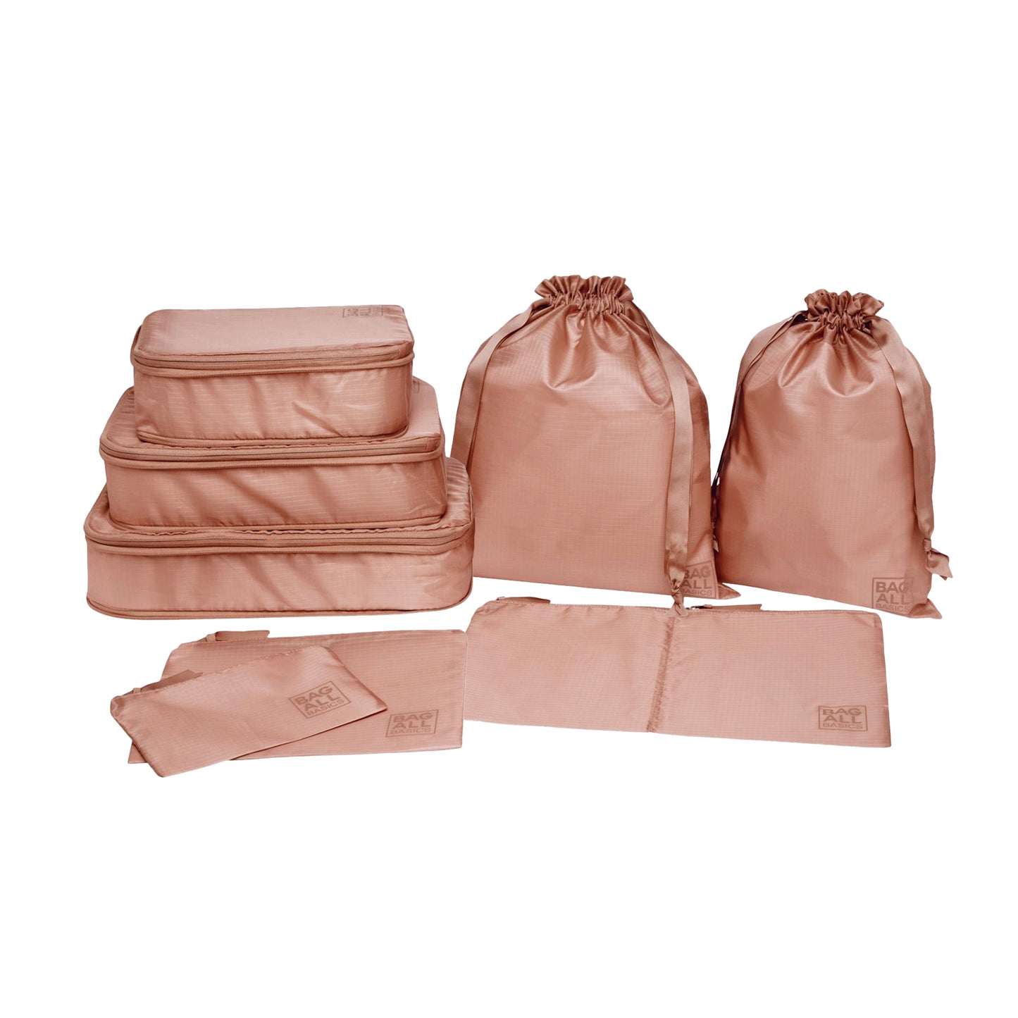 Bag-all Compression Cubes & Packing Bags Set in pink/blush featuring 8 recycled nylon organizers including compression cubes, packing cases, and drawstring bags for travel