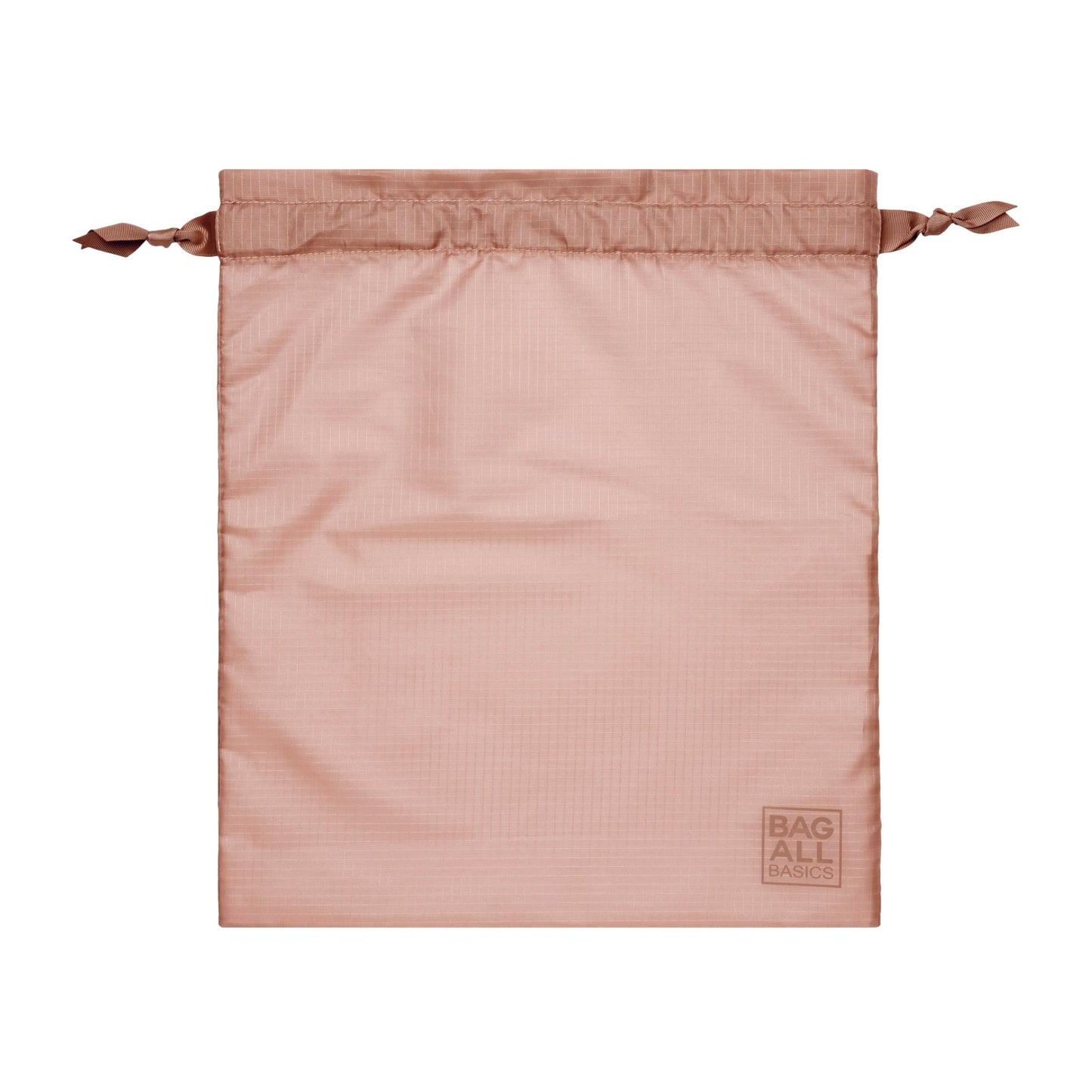Bag-all Compression Cube in blush pink, made from recycled nylon with drawstring closure and signature logo tag, part of 8-piece travel organizer set
