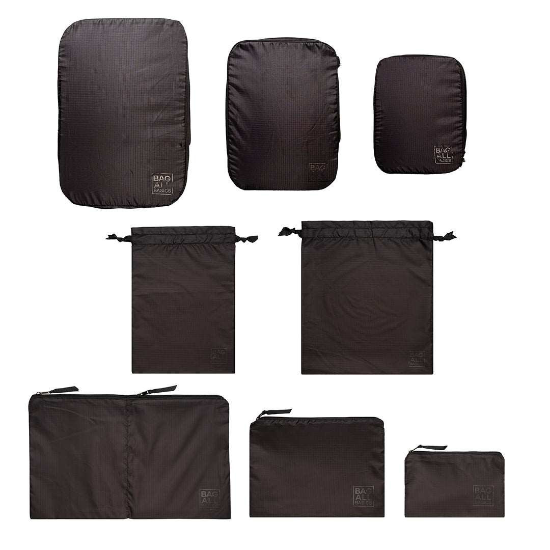 Bag-all Compression Cubes & Packing Bags Set in black nylon featuring 8 versatile pieces: 3 compression cubes, 3 packing cases, and 2 drawstring bags for travel organization