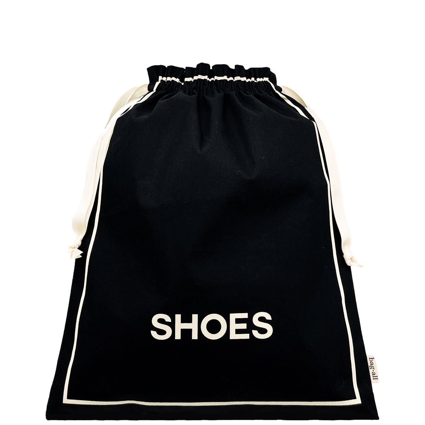 Bag-all Couture Shoe Travel Bag in classic black cotton with white trim and 'SHOES' text, featuring drawstring closure and elegant minimalist design