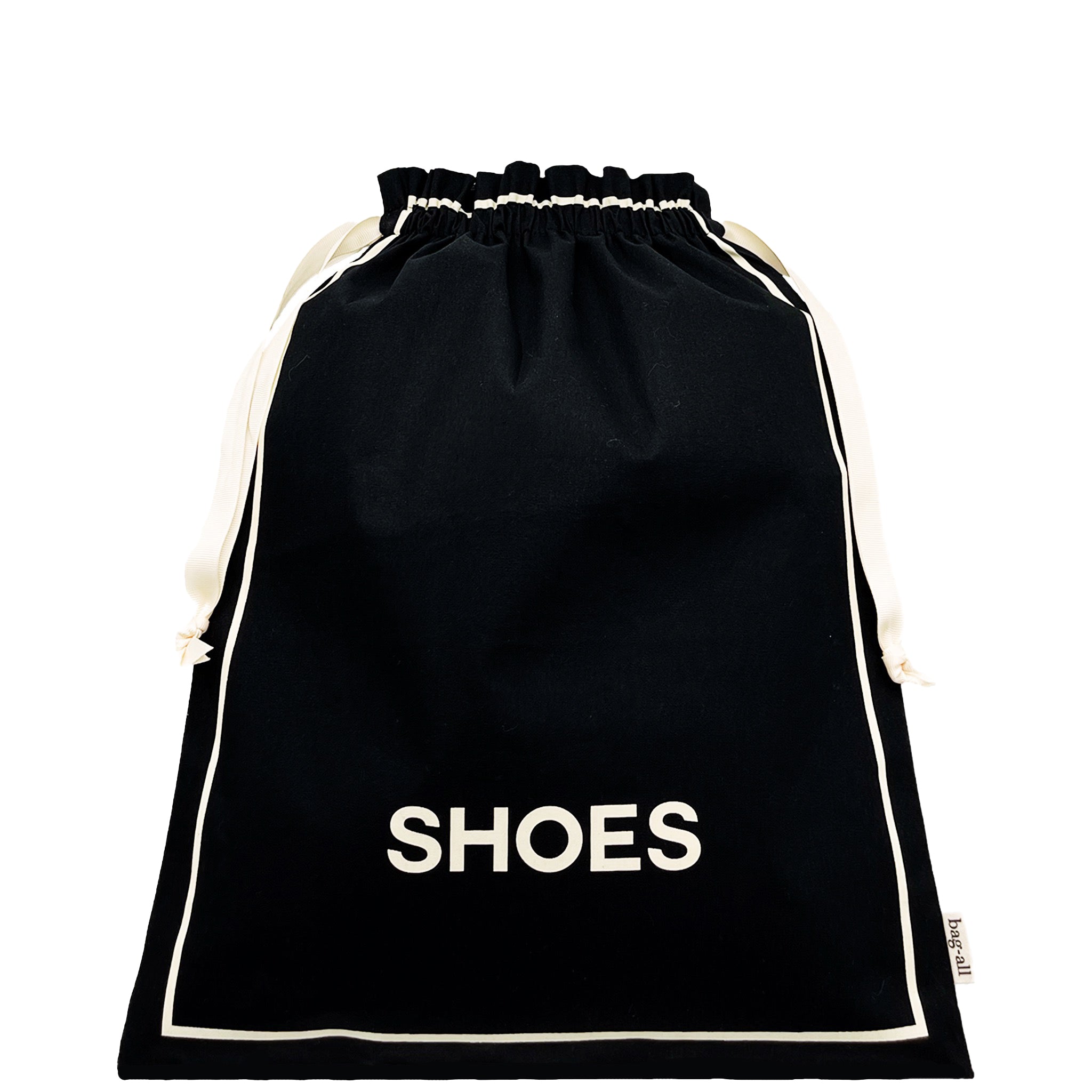 Bag-all Couture Shoe Travel Bag in classic black cotton with white trim and 'SHOES' text, featuring drawstring closure and elegant minimalist design