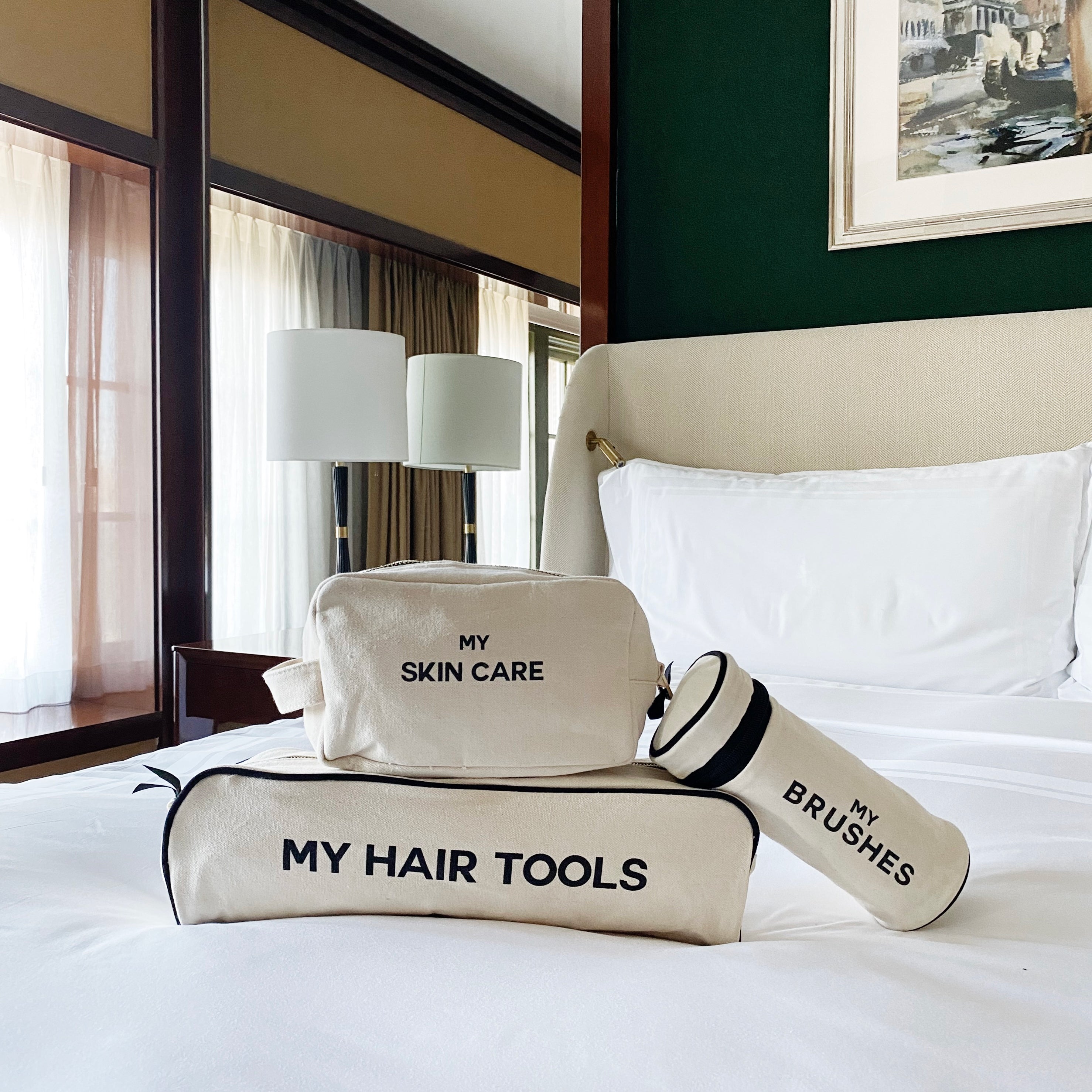 Bag-all Pamper Gift Set Deal 3-Pack in cream cotton featuring My Hair Tools case, Brushes case, and My Skin Care pouch, perfectly organized on crisp white bedding with modern decor