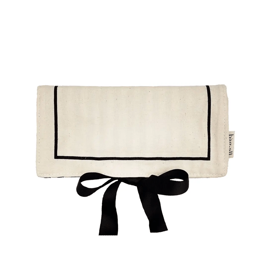 Bag-all cream jewelry case travel roll with black trim and bow tie closure for organized jewelry storage