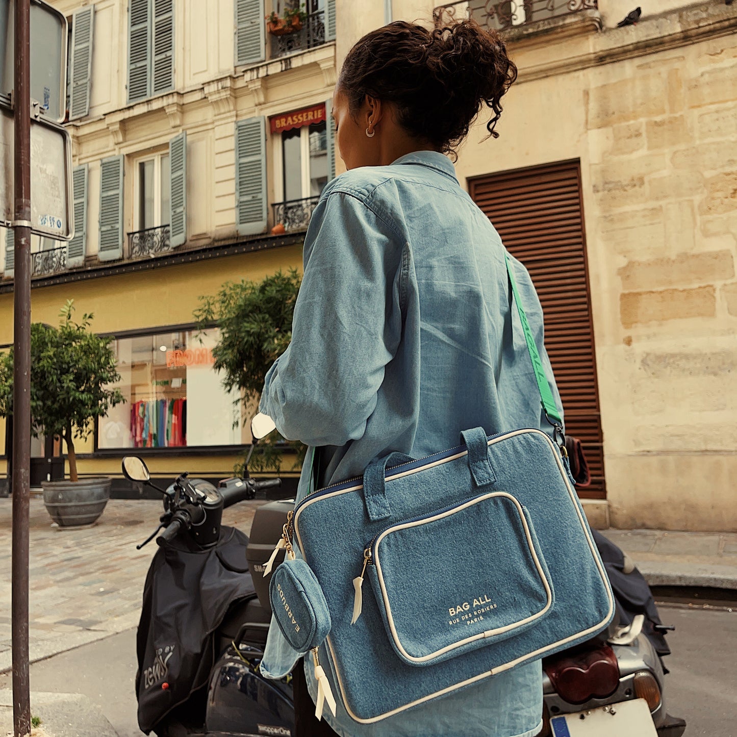 Bag-all denim laptop case 13" with convenient charger pocket, gold chain strap, and striped interior padding, perfect for modern urban mobility