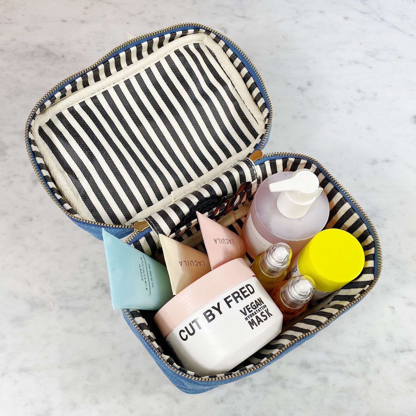Bag-all My Makeup Cosmetic Box in Denim featuring striped interior lining, waterproof material, and spacious storage for beauty essentials and travel organization