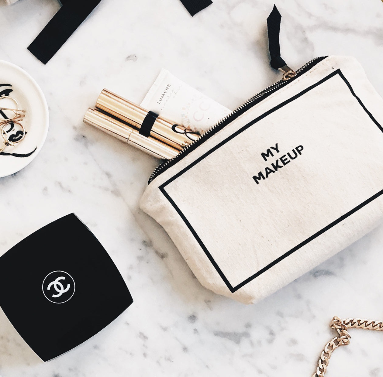Bag-all cream cotton makeup pouch labeled My Makeup with cosmetics and accessories on marble surface gallery one