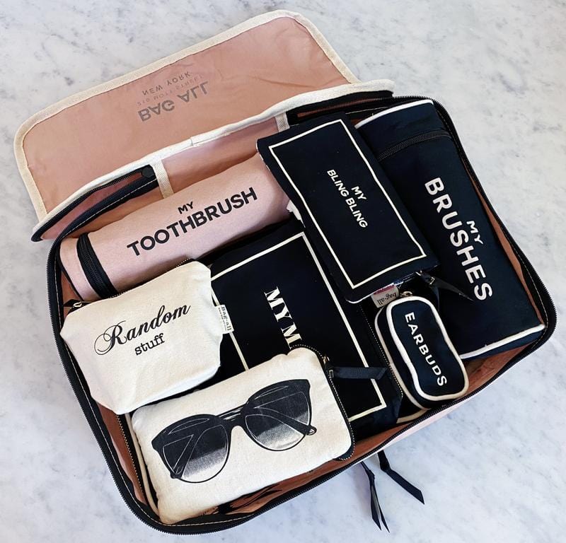 Bag-all Pink Toothbrush Travel Case holds multiple toothbrushes and toiletries in organized compartments, featuring a sleek design in blush pink with black labeled sections for efficient travel storage