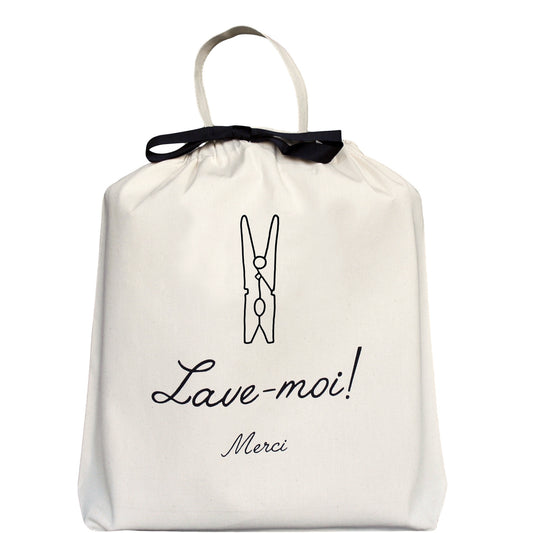 Bag-all Lave-moi Merci French Laundry Bag in cream cotton featuring black clothespin illustration and French text, with elegant black ribbon drawstring closure and carrying handle