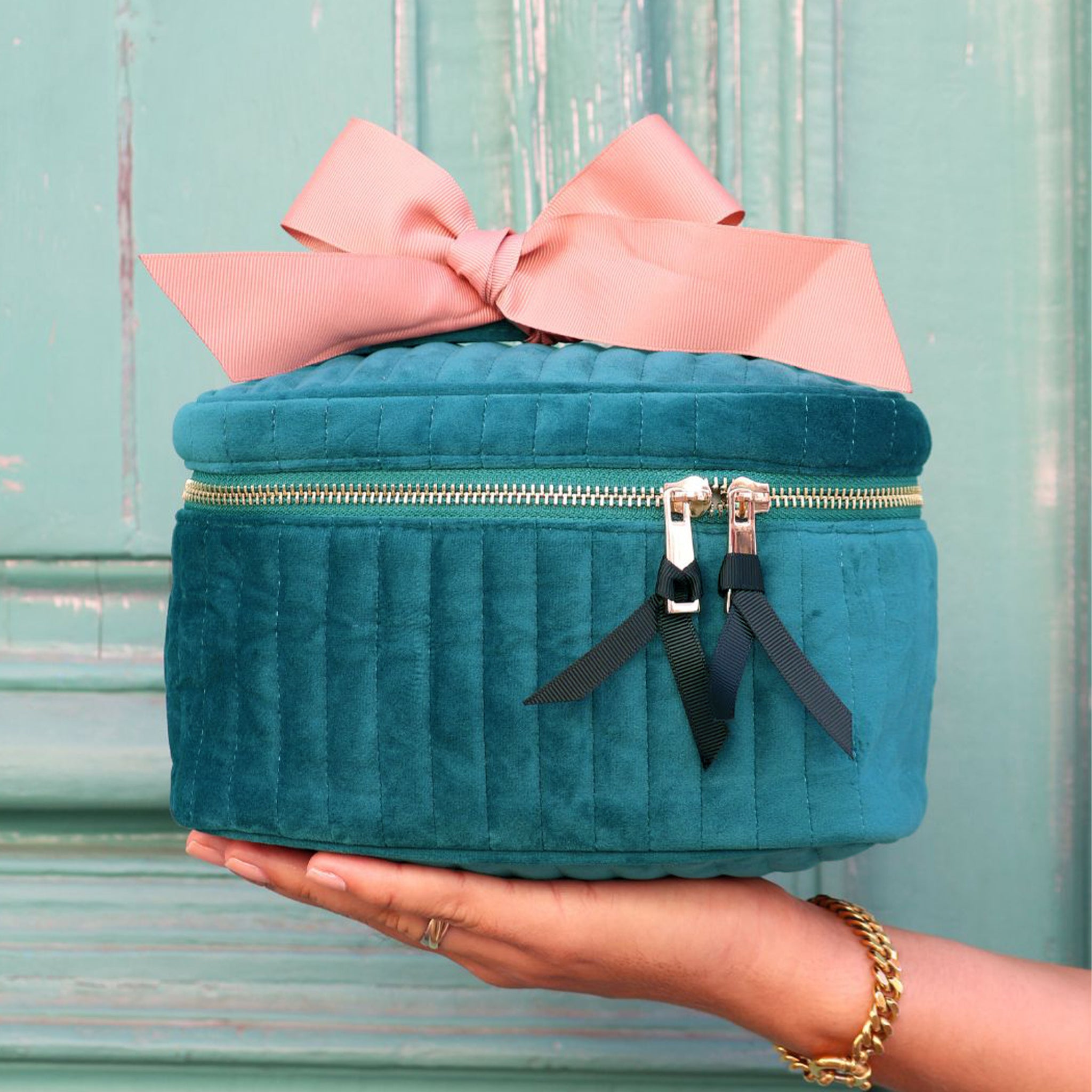 Quilted teal eco velvet makeup case with gold zipper and pink bow, stylish Bag-all accessory for beauty essentials