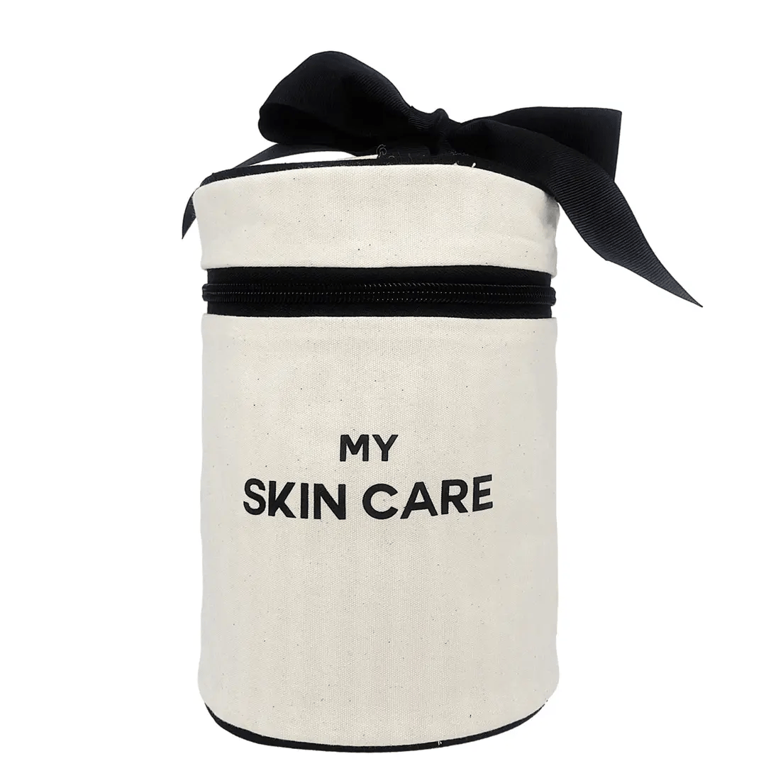 Bag-all Round Skin Care Case with Handle in cream canvas, featuring black text 'MY SKIN CARE', black zipper, and decorative bow, perfect for beauty storage