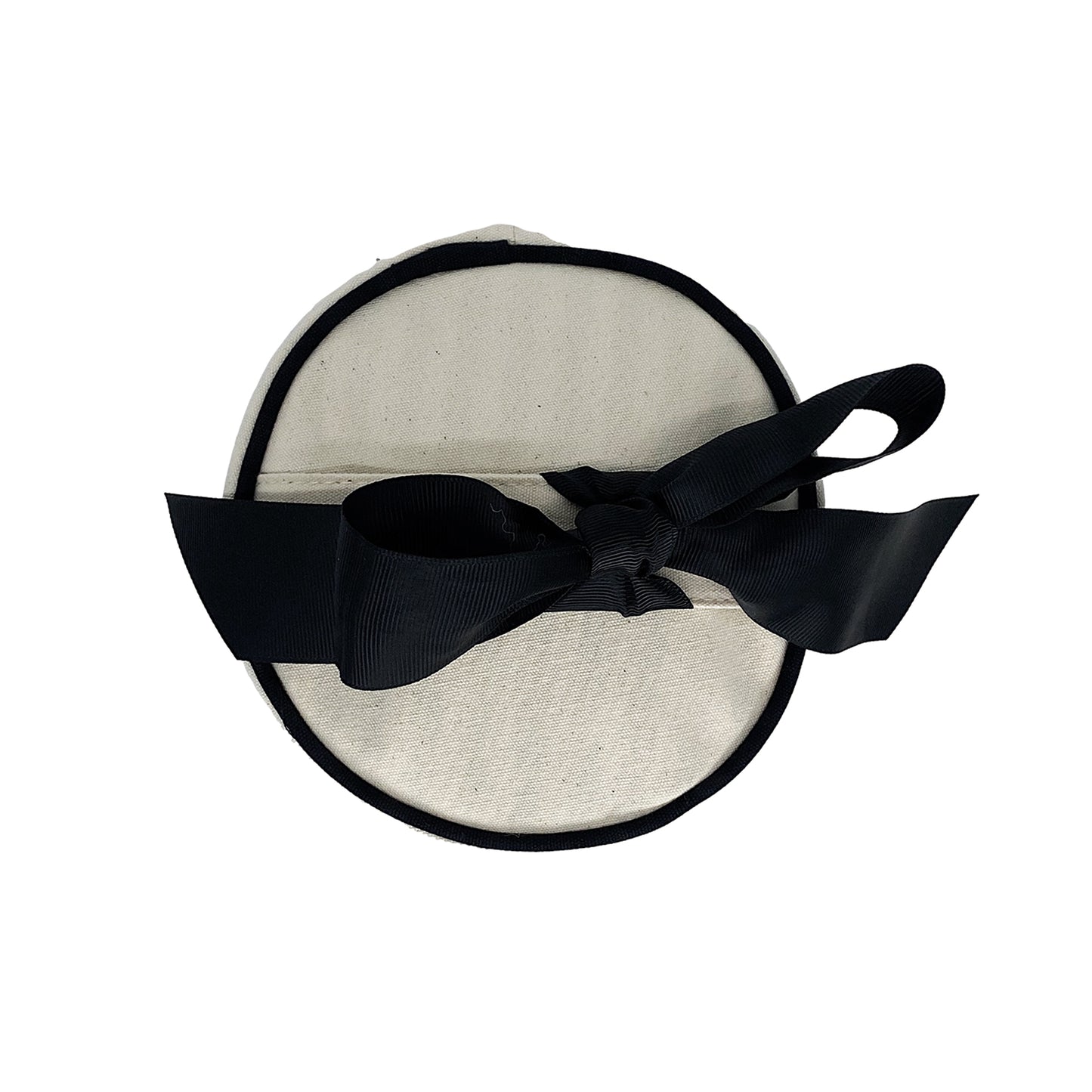 Bag-all Round Skin Care Case with Handle in cream canvas featuring black trim and elegant bow accent, top view of cylindrical travel organizer for beauty products