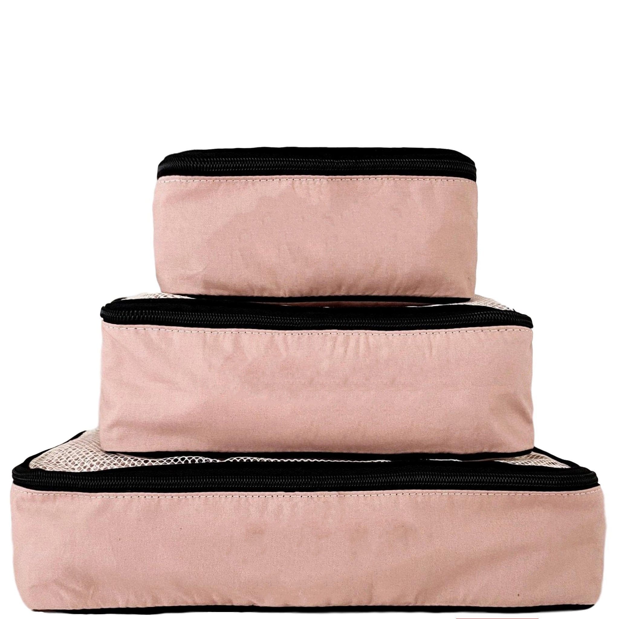 Bag-all Travel Glam 4-Pack organizer set in pink/blush featuring packing cubes, lingerie pouch, makeup box, and tech pouch with black trim accents