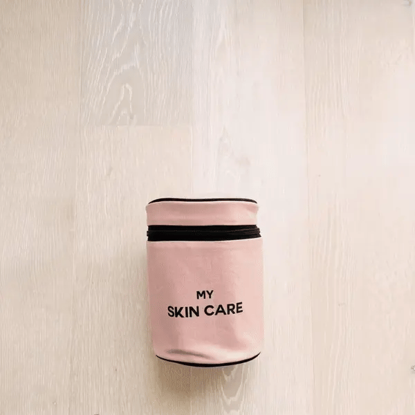 Bag-all Round My Skin Care Case in pink blush, a cylindrical travel organizer with secure bands and waterproof lining for skincare products