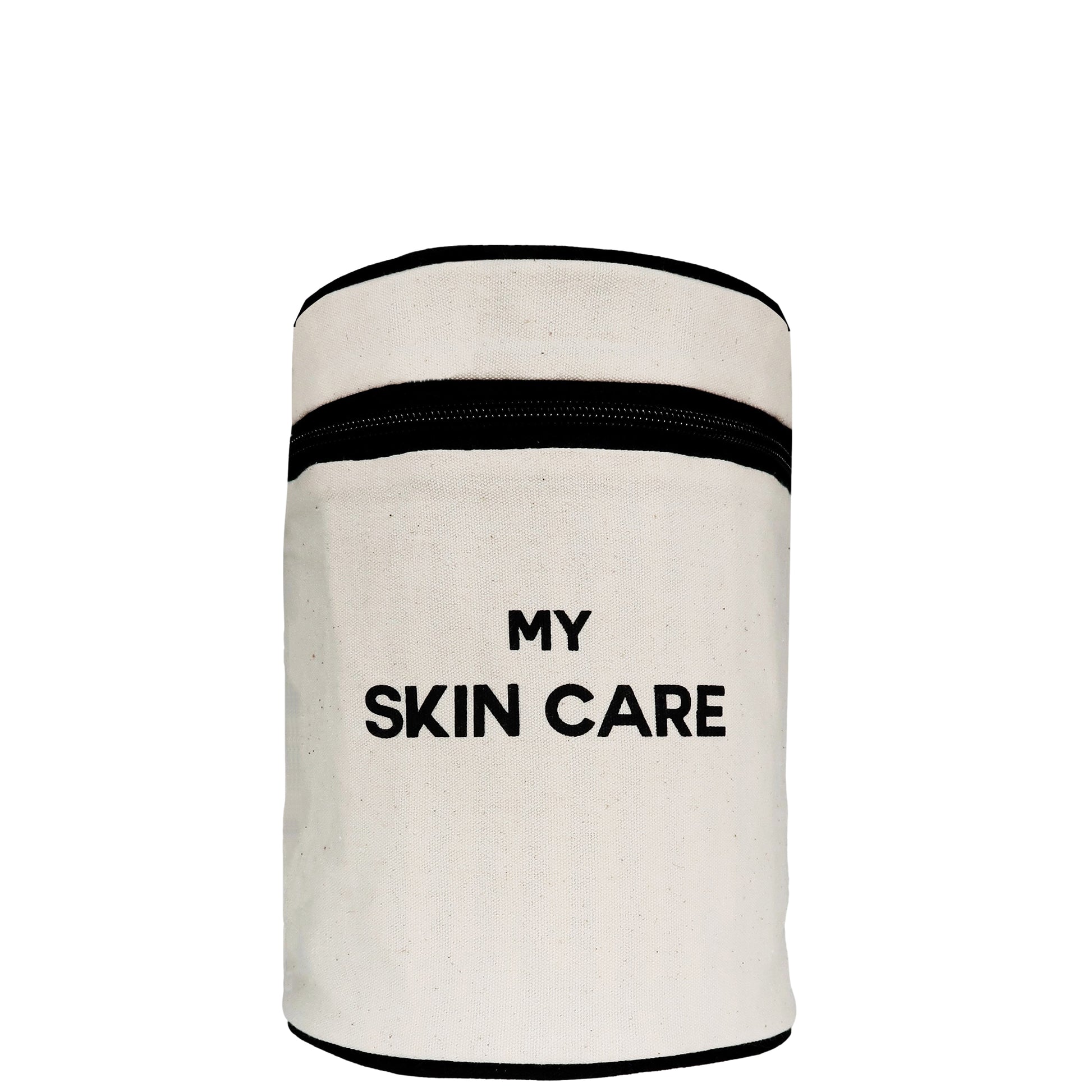 Bag-all Round My Skin Care Case in cream canvas with black trim, featuring organized compartments and water-resistant lining for stylish skincare storage