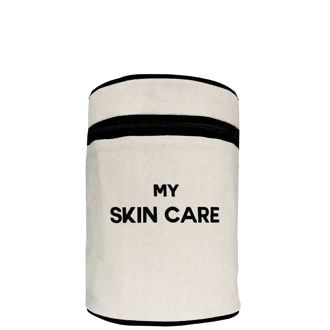 Bag-all Round My Skin Care Case in cream - cylindrical organizer with black trim and text, featuring waterproof lining and internal compartments for skincare storage