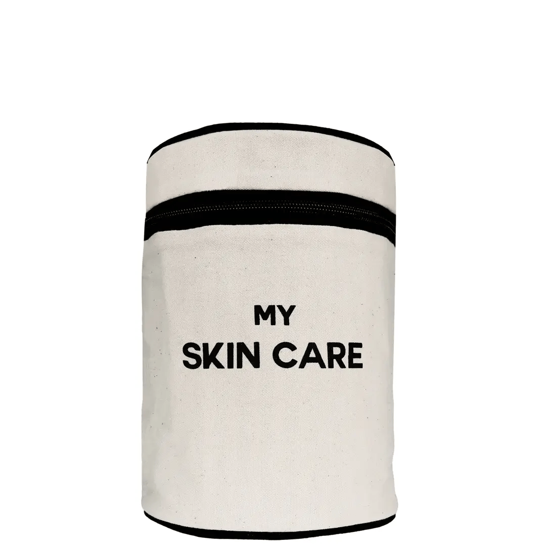 Bag-all Round My Skin Care Case in cream - cylindrical organizer with black trim and text, featuring waterproof lining and internal compartments for skincare storage