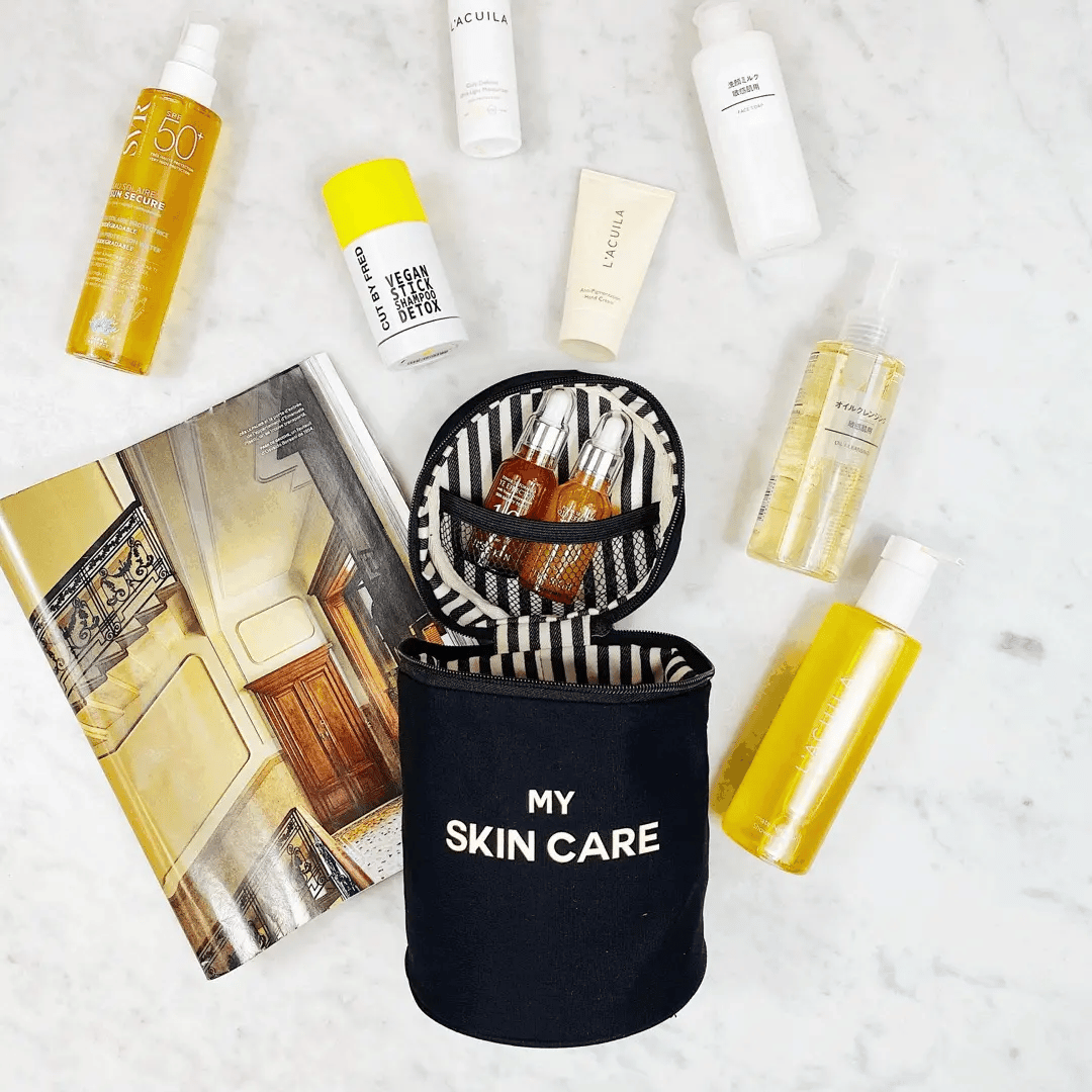 Bag-all Round Skin Care Case with Handle in black, shown open with organized skincare products, featuring striped interior lining and mesh compartment for secure storage