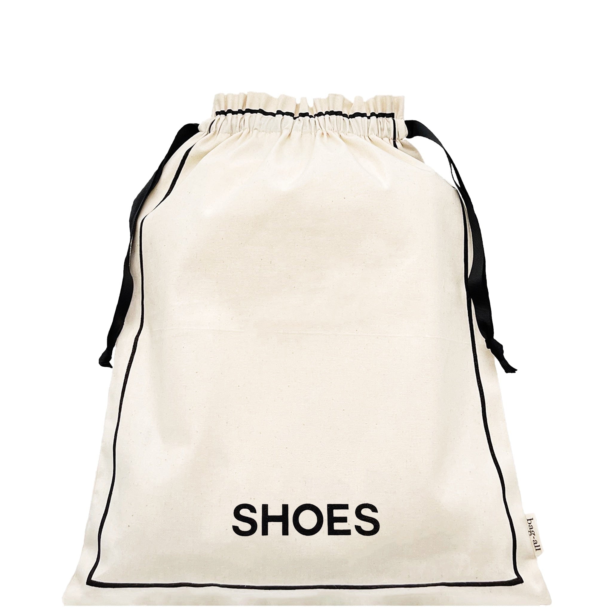 Bag-all Couture Shoe Travel Bag in cream canvas with black drawstring closure and SHOES text print, perfect for organized footwear storage and travel