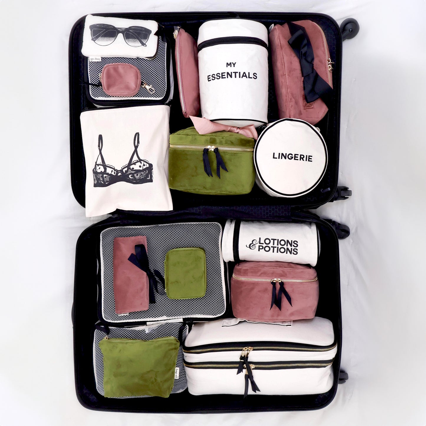 Bag-all My Makeup Pouch organized with travel accessories, pouches, and organizers in pink, green, and white, featuring labeled compartments for essentials, lingerie, and beauty products