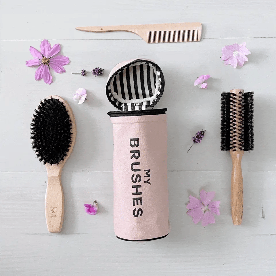 Pink blush Hair Ritual Deal Gift Set with 3 brushes and tools organizer by Bag-all with floral decor on white surface