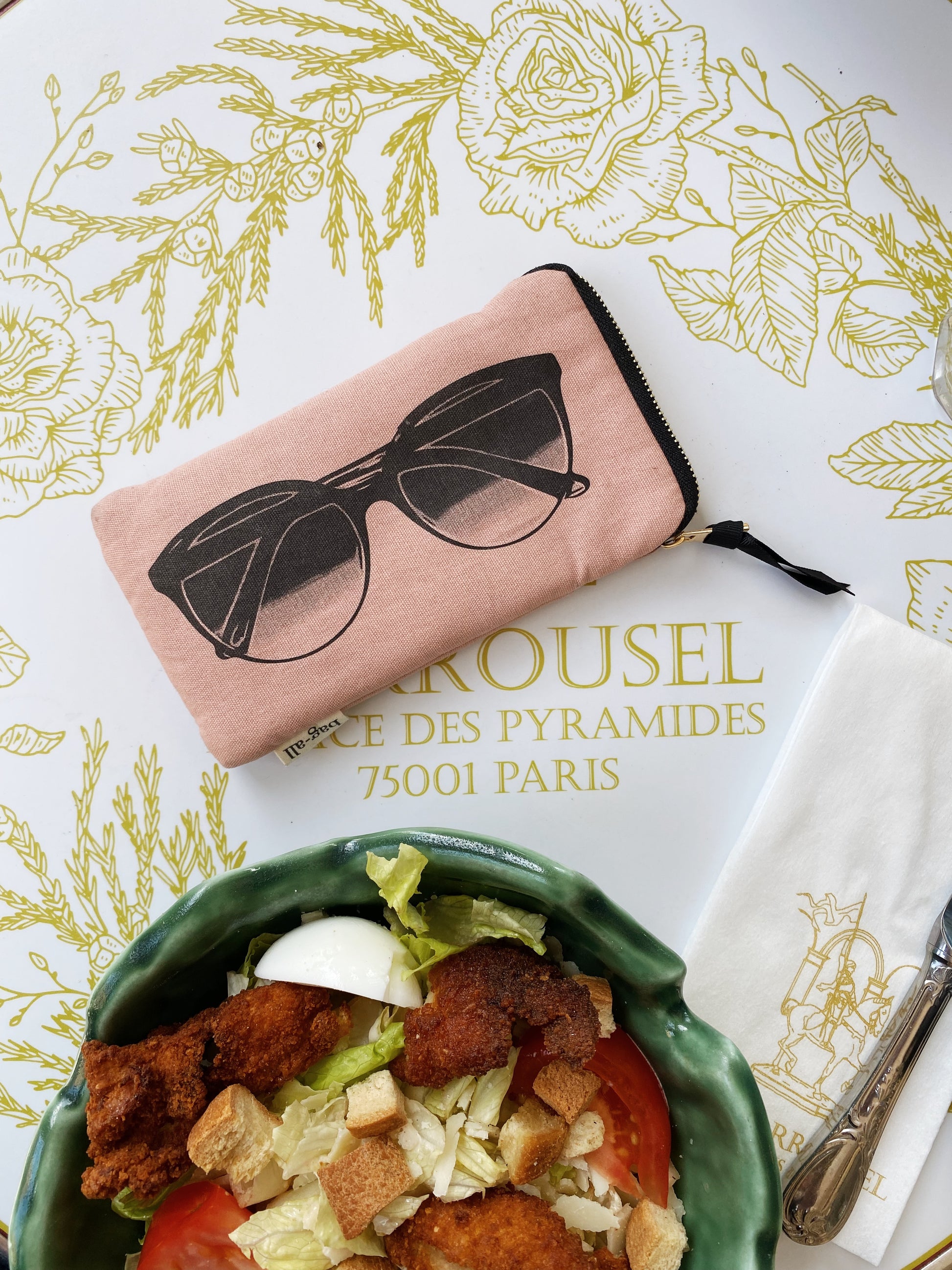 Bag-all Glasses Case with Outside Pocket in blush pink features sunglasses print, gold zipper, and extra storage pocket. Stylish protective case for eyewear and small accessories.