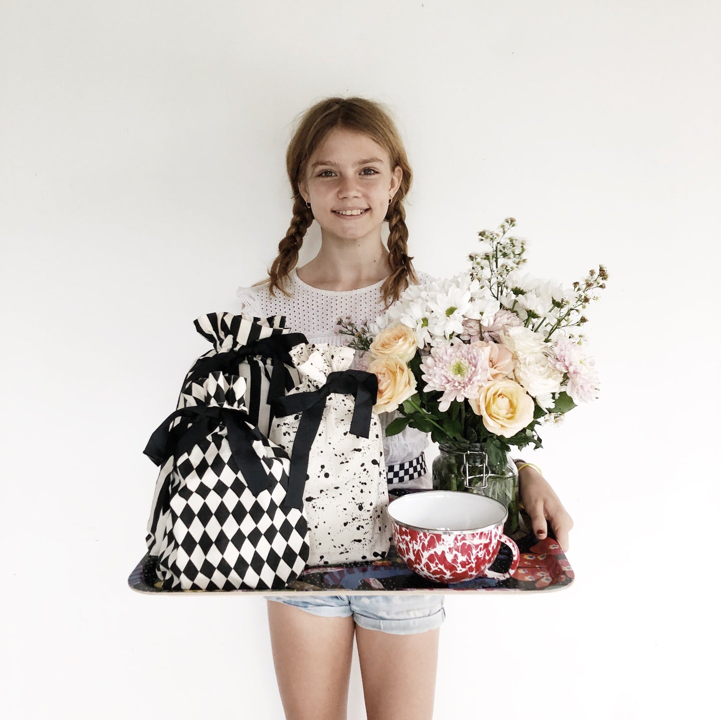 Bag-all Gift Bag Diamond Small: Reusable black and white diamond patterned fabric gift bag displayed with flowers and decorative items on serving tray, perfect for eco-friendly gift wrapping