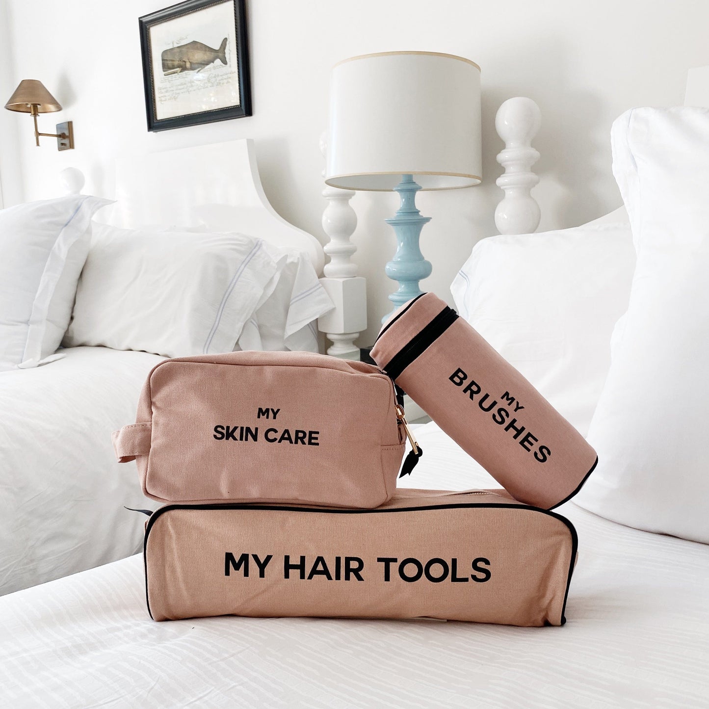 Bag-all Pamper Gift Set Deal 3-Pack: Pink/Blush cotton organizer set featuring Hair Tools Case, Brushes Case, and Skin Care Pouch, elegantly displayed on white bedding with decorative lamp