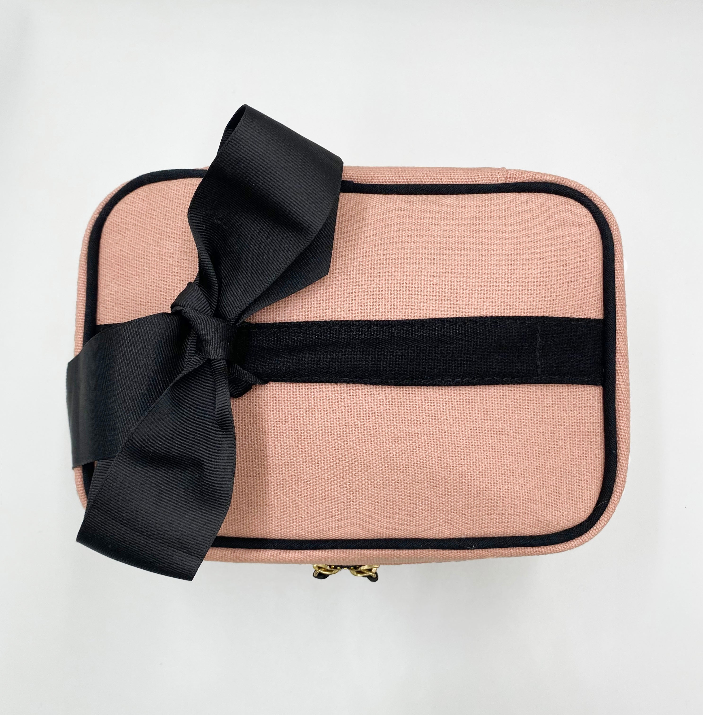 Bag-all pink meds and first aid storage box with black cross print, decorative black bow, zippered closure and carrying handle, perfect for organizing medical supplies