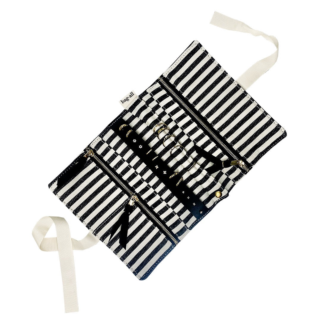 Bag-all Jewelry Organizer Travel Pouch in black and white stripes, featuring three zippered compartments, leather earring holder and padded ring storage with elegant ribbon ties