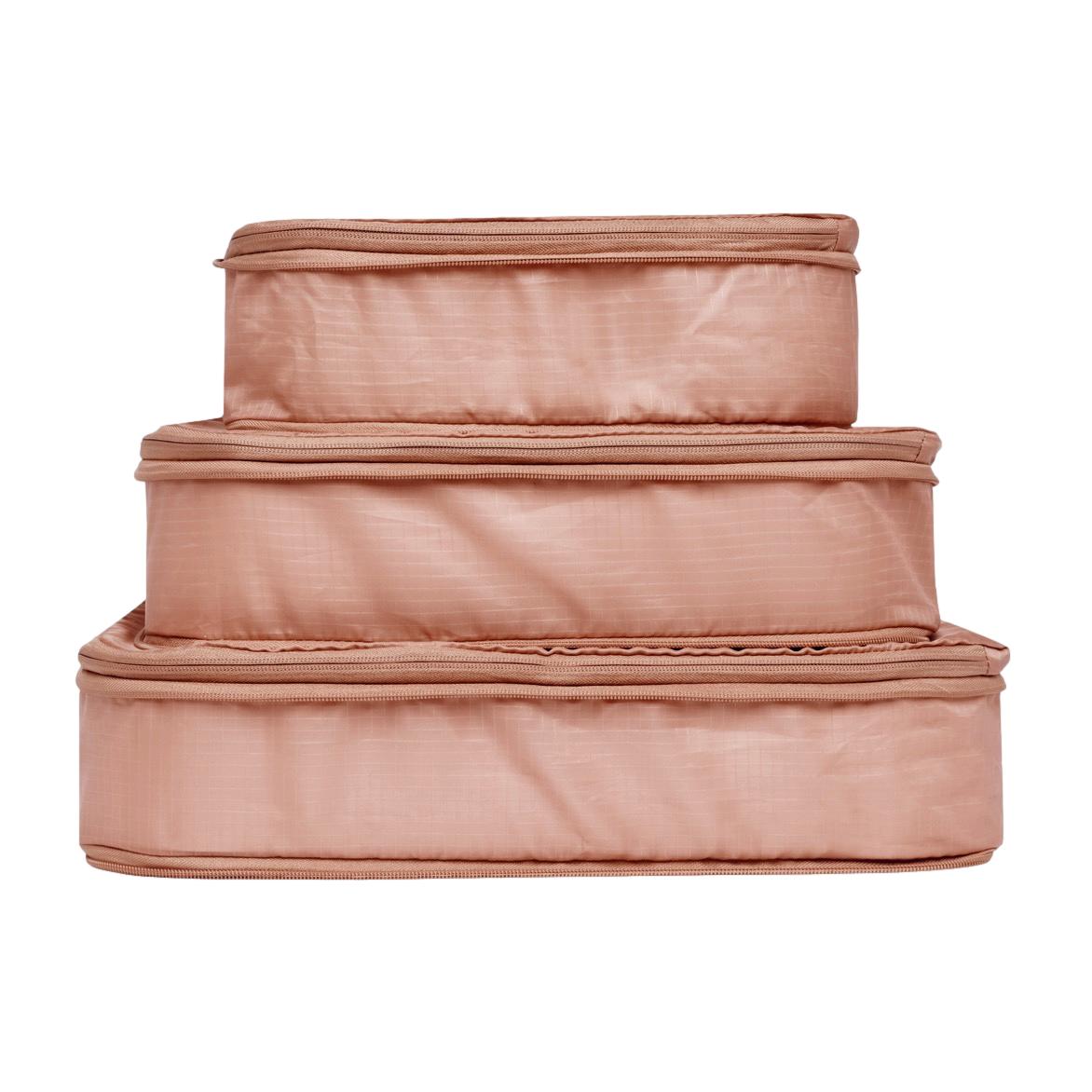 Bag-all Pink Recycled Nylon Compression Packing Cubes 3-pack, stacked in descending size order, eco-friendly travel organizers in blush color with reinforced seams