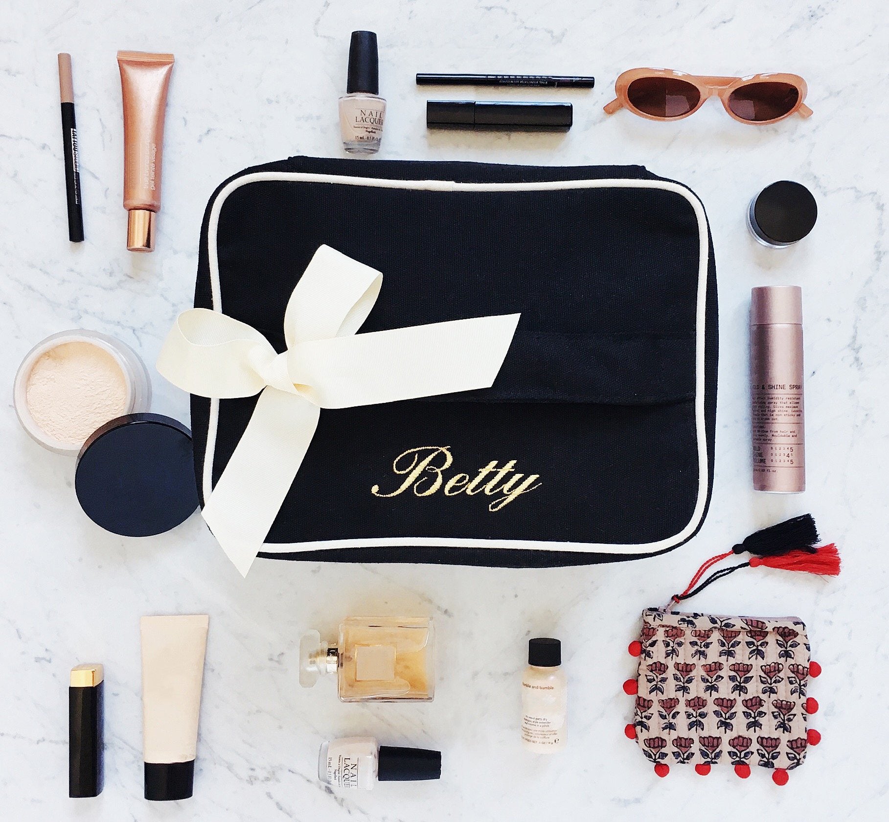 Bag-all My Vanity Large Beauty Box in black with white trim and bow, surrounded by makeup essentials, perfume, and sunglasses on marble surface - perfect beauty organizer case