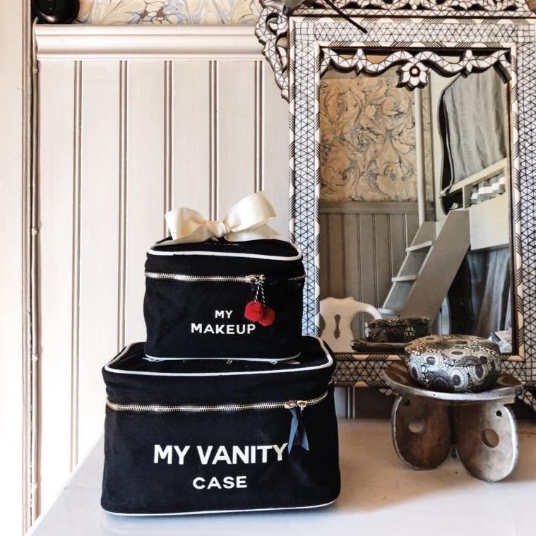 Bag-all My Makeup Cosmetic Box in black canvas with white trim and bow, stacked with matching Vanity Case, featuring waterproof interior and elegant embroidered text