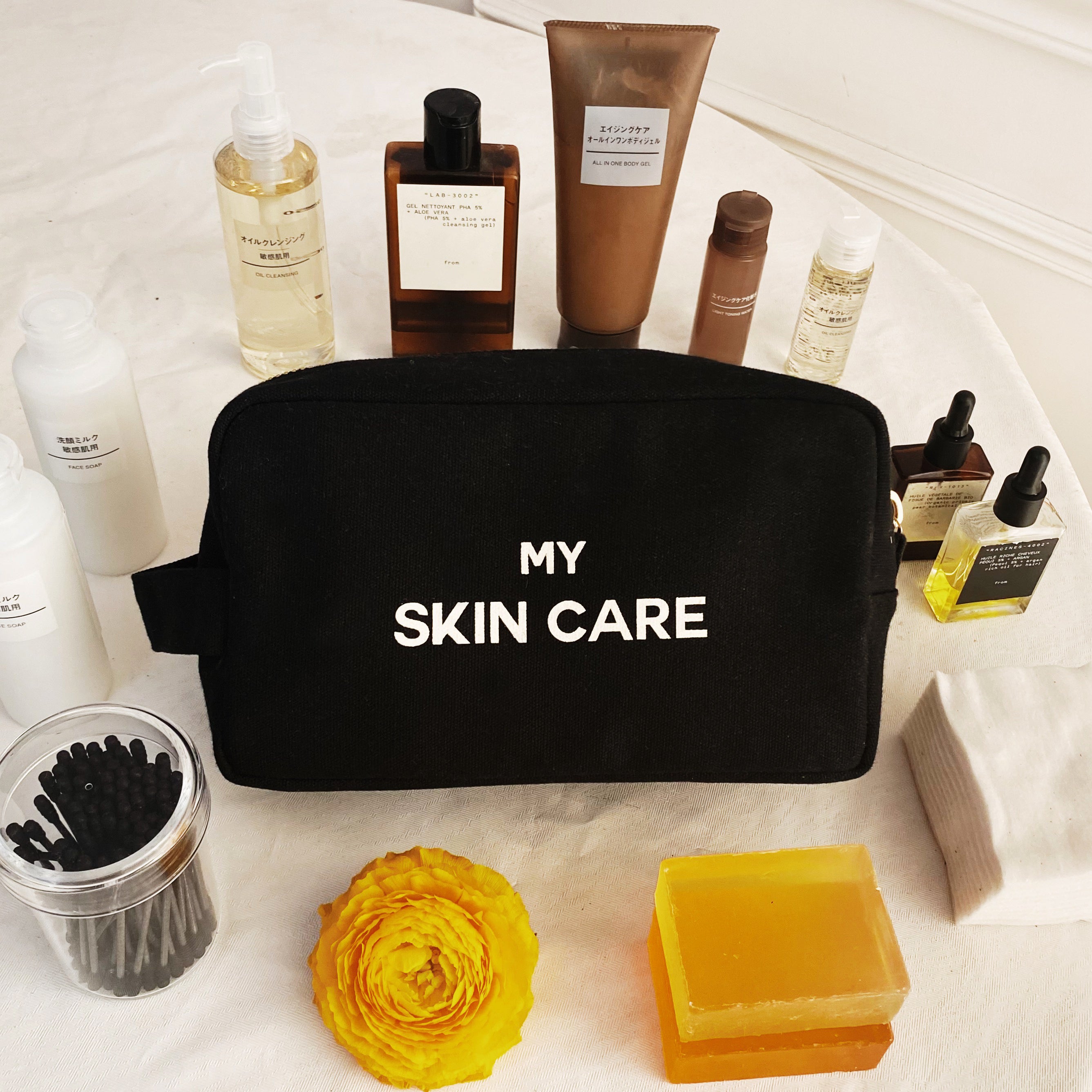 Bag-all My Skin Care Organizing Pouch in black cotton with gold zipper, perfect for storing beauty products, featuring waterproof interior and stylish white text design