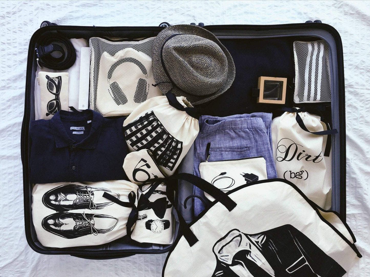 Bag-all Men's Accessories Bag in cream organizes gentleman's essentials - headphones, hat, shoes, shirts, and accessories neatly packed in stylish cotton storage solution for travel or wardrobe