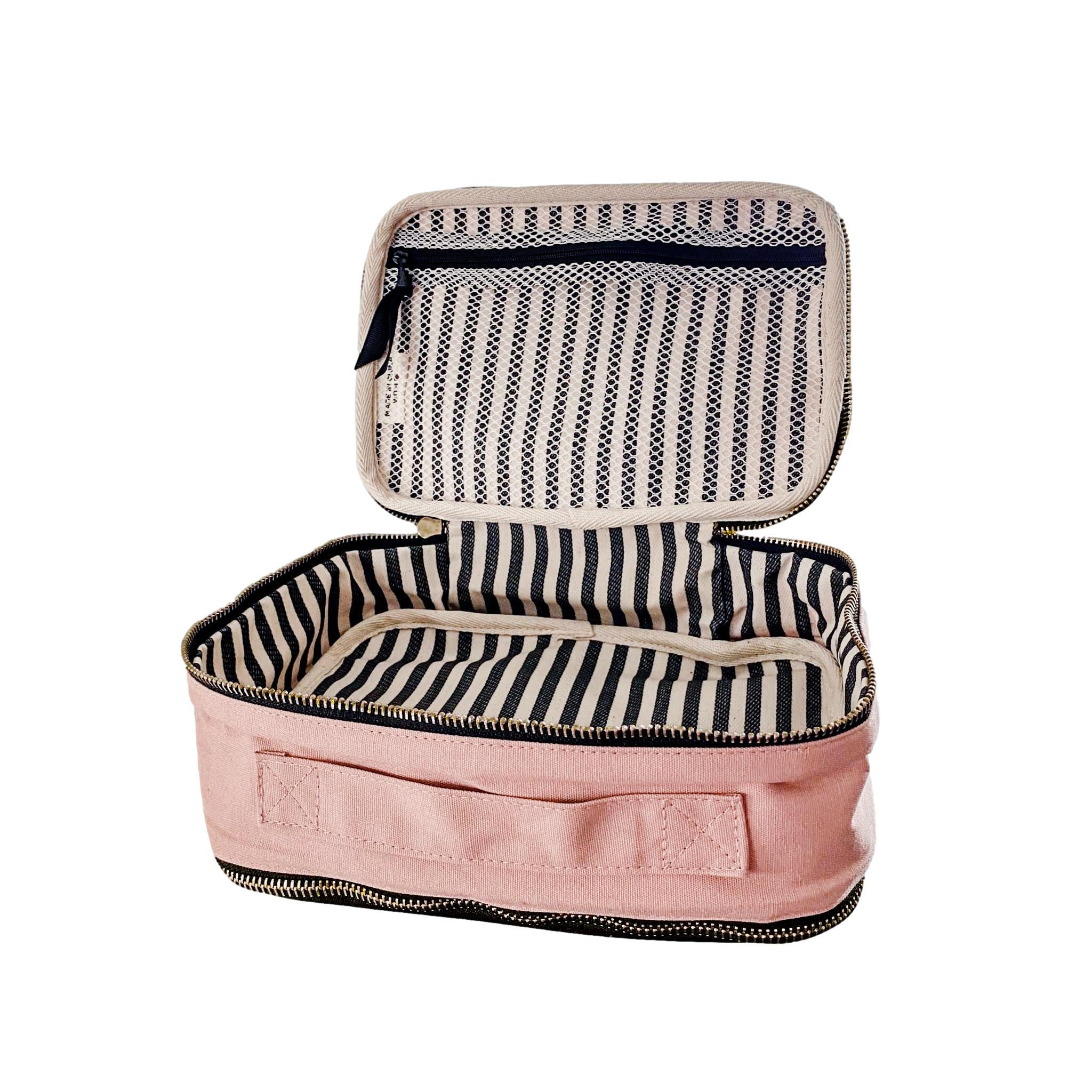 Bag-all double-sided pink blush makeup case with striped interior and zippered compartments for organized storage