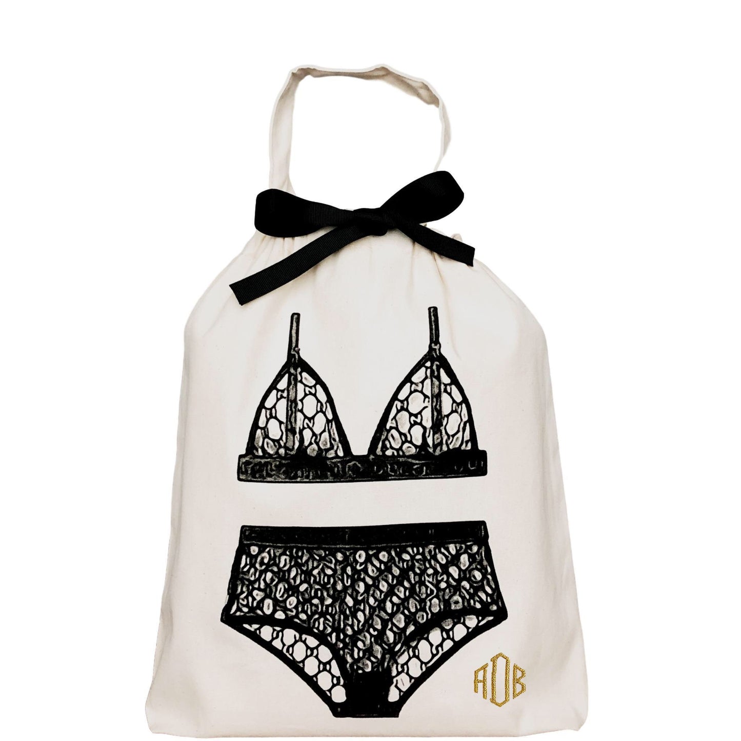 Bag-all London Lingerie Travel Bag in cream cotton with black lingerie illustration, featuring monogram and elegant black bow, perfect for organizing delicate undergarments