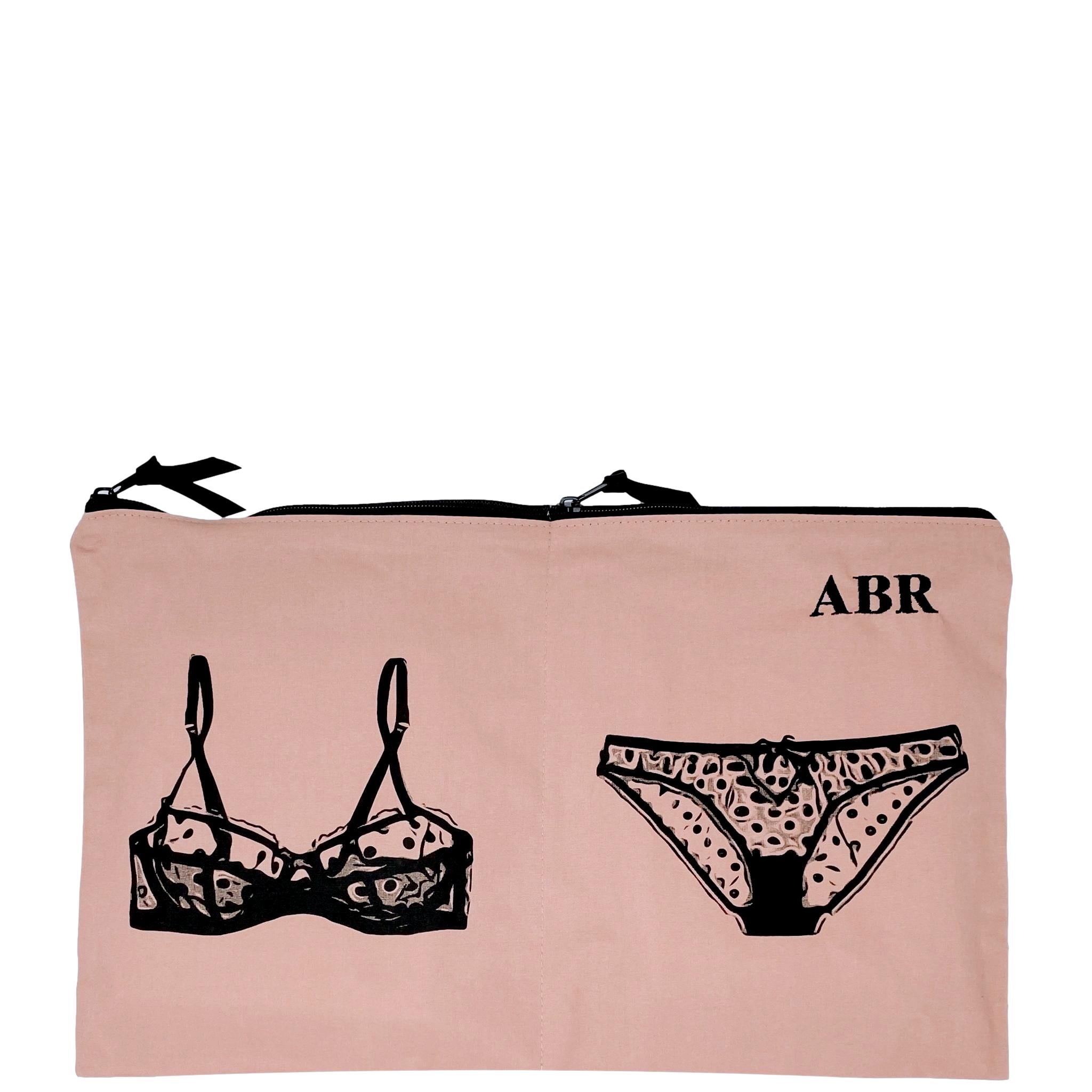 Bag-all Double Lingerie Packing Pouch in pink/blush featuring black illustrated bra and panty design with dual compartments and metal zippers, perfect for travel organization