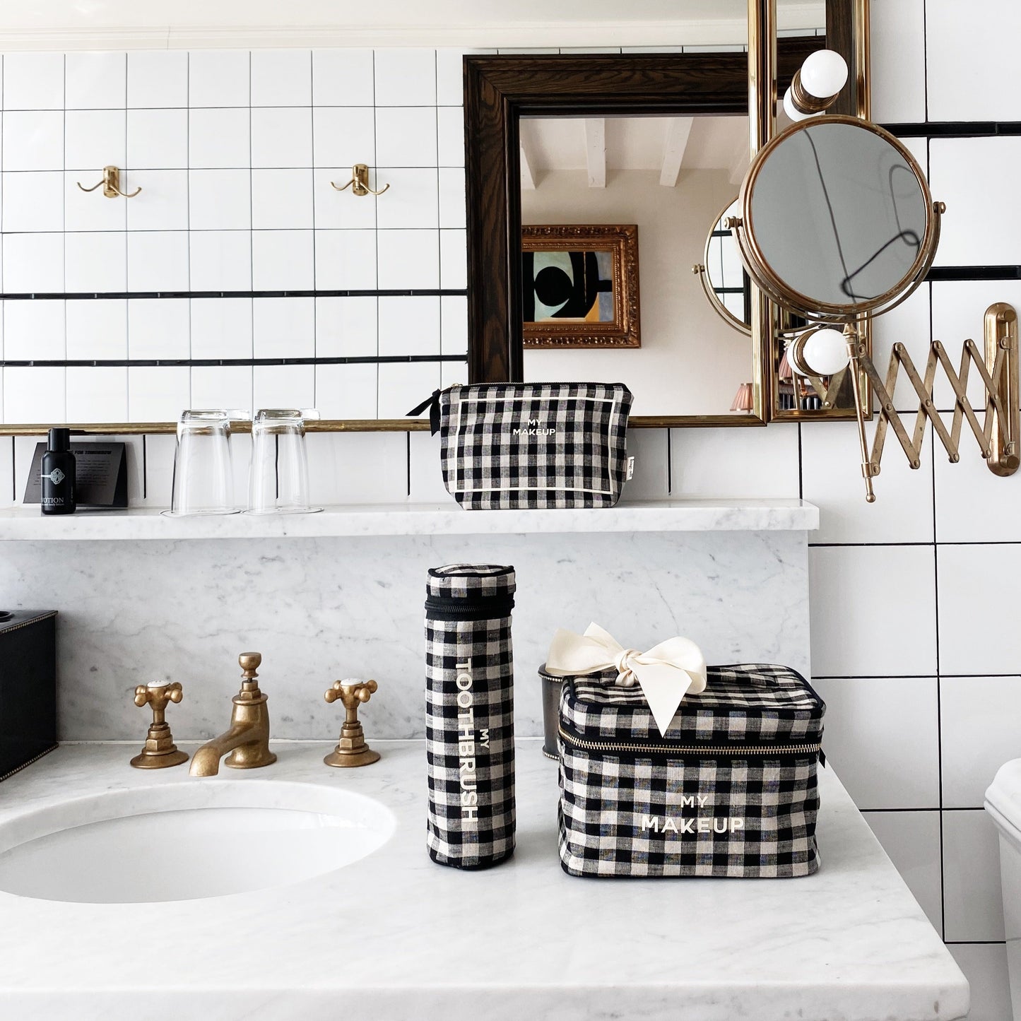 Bag-all My Makeup Pouch in stylish black and white gingham pattern with gold zipper and waterproof interior, perfect for organizing cosmetics and travel essentials