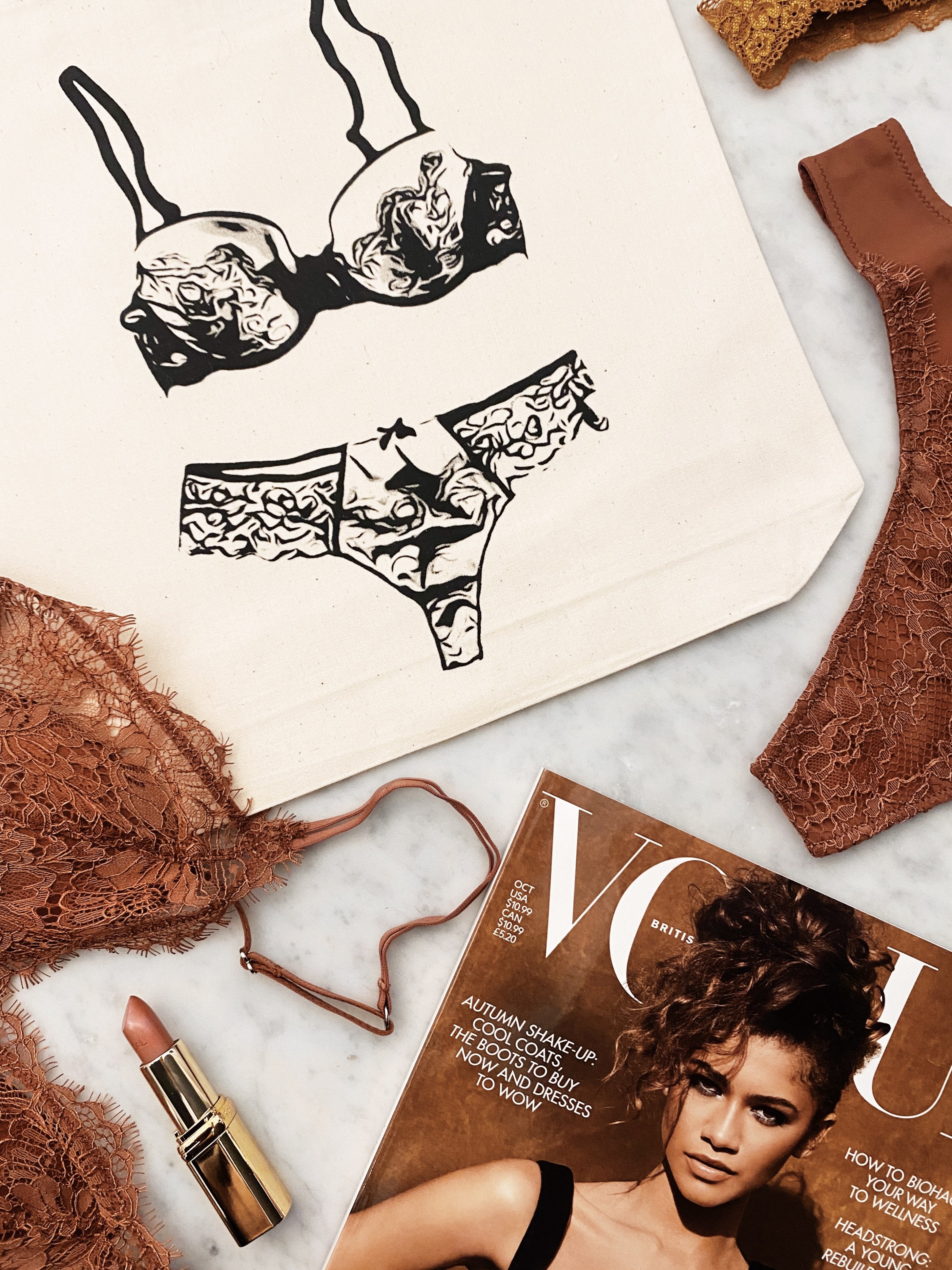 Bag-all Cream Lace Lingerie Travel Bag featuring elegant black and white lingerie illustration on cotton canvas, styled with vintage magazine and beauty accessories