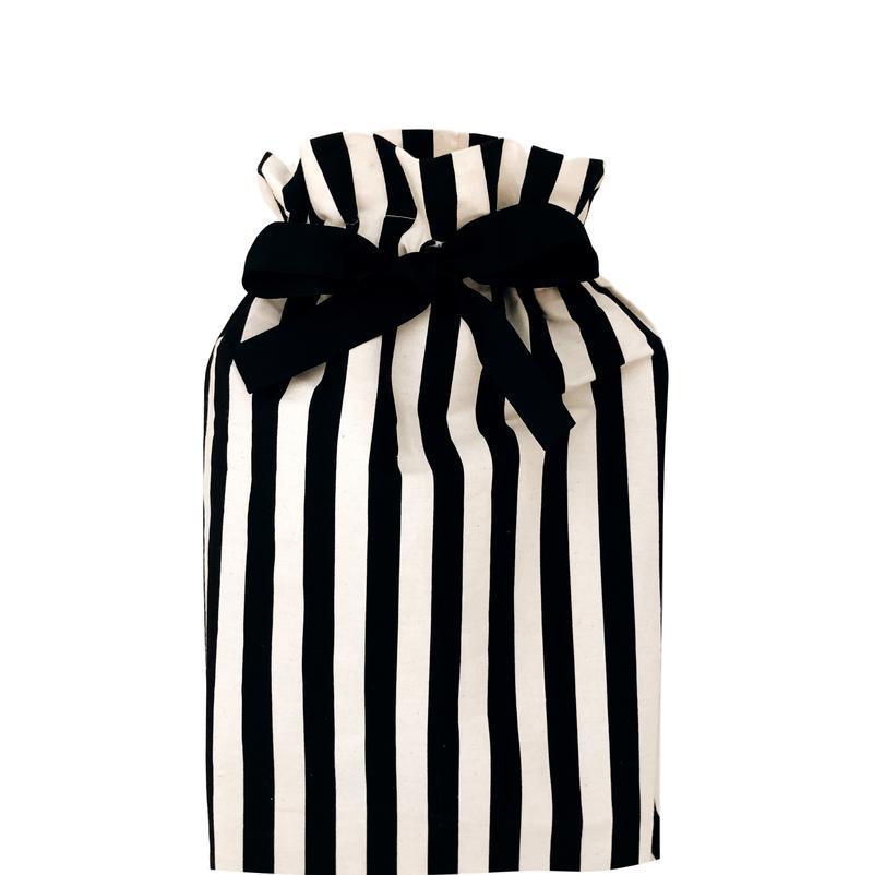 Bag-all Gift Bag Striped Medium - Reusable cotton gift bag with black and white vertical stripes and elegant black bow closure, perfect for sustainable gift wrapping