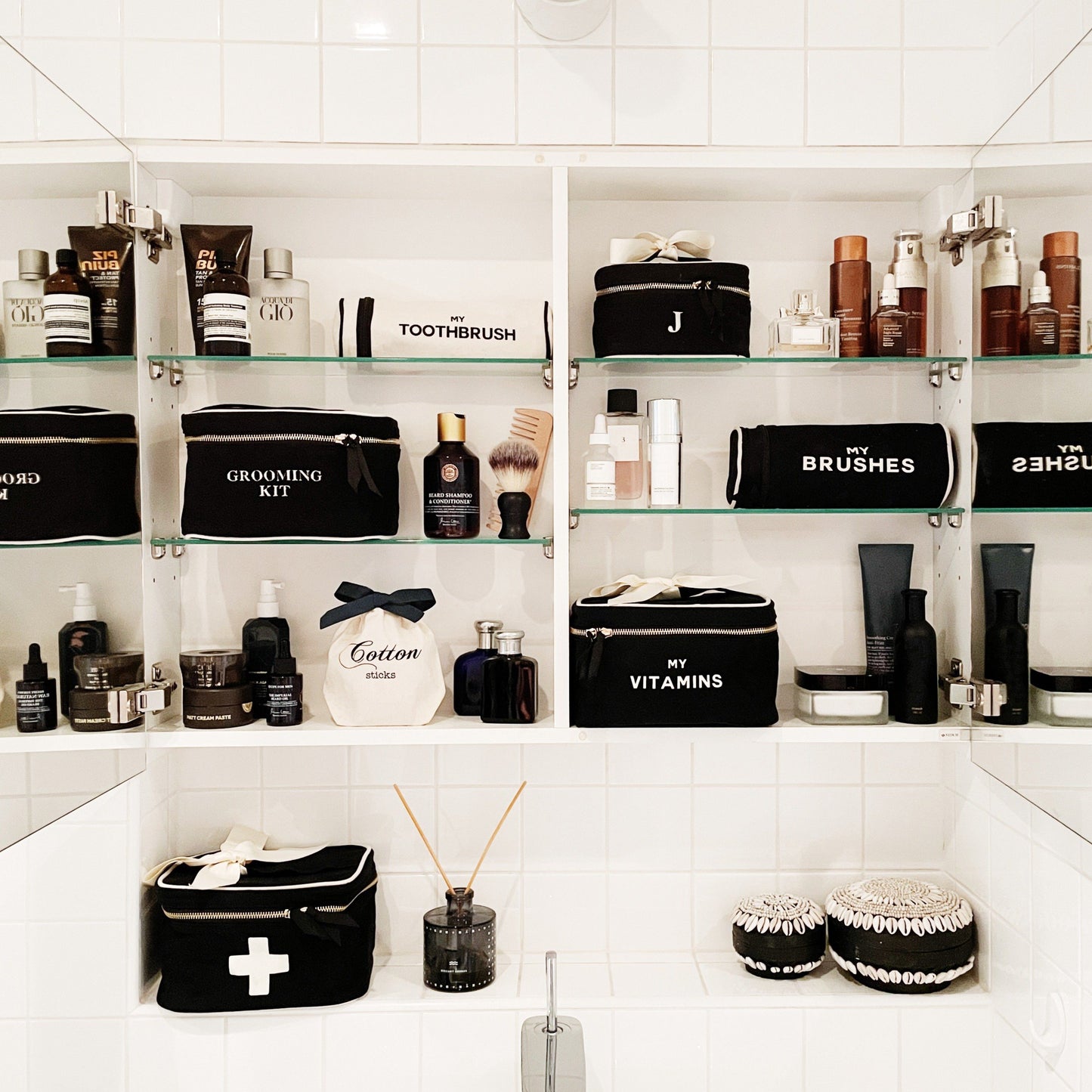 Bag-all Black Vitamins Storage and Travel Box shown in organized bathroom cabinet with grooming essentials and personal care items on white shelving, displaying stylish storage solution