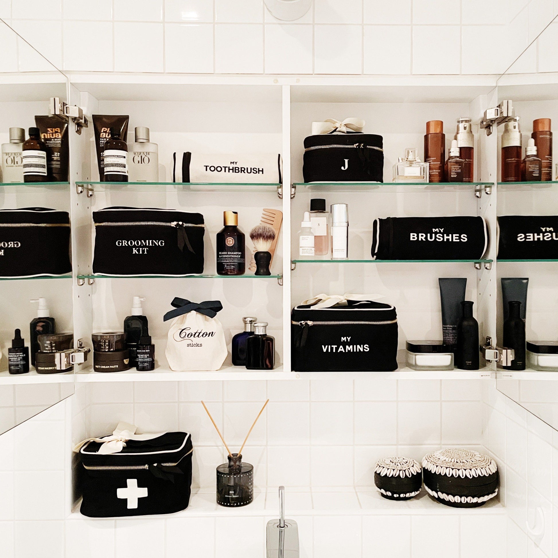 Bag-all Black Vitamins Storage and Travel Box shown in organized bathroom cabinet with grooming essentials and personal care items on white shelving, displaying stylish storage solution