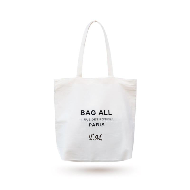 Bag-all Paris Le Marais Tote - Cream cotton zipper tote bag with inside pocket, featuring rue des Rosiers address and monogram option. Stylish reusable shopping bag for everyday use.
