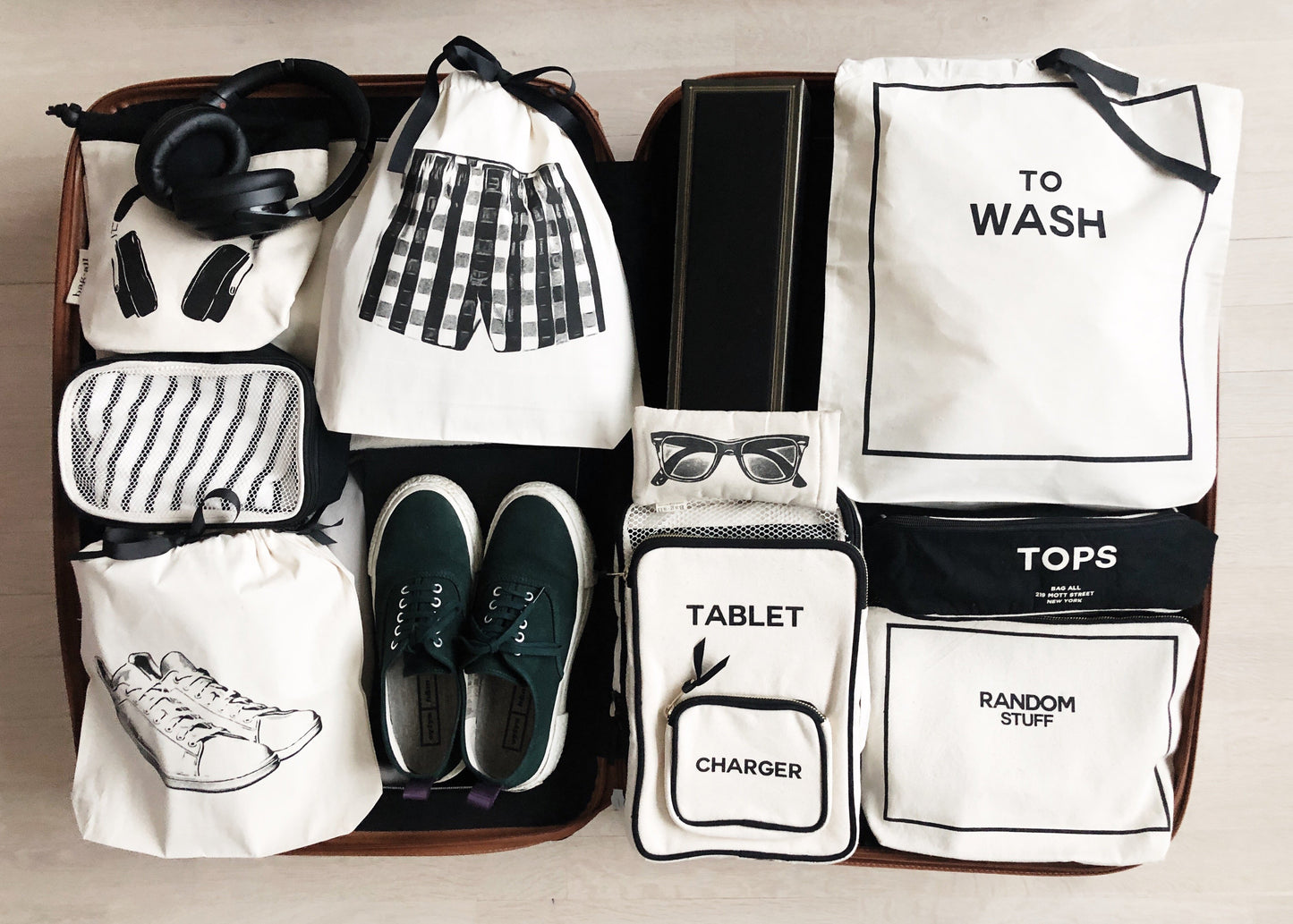 Bag-all White Sneaker Shoe Bag in cream cotton features organized travel storage bags including shoe bags, wash bags, and tech accessories pouches arranged in a neat layout