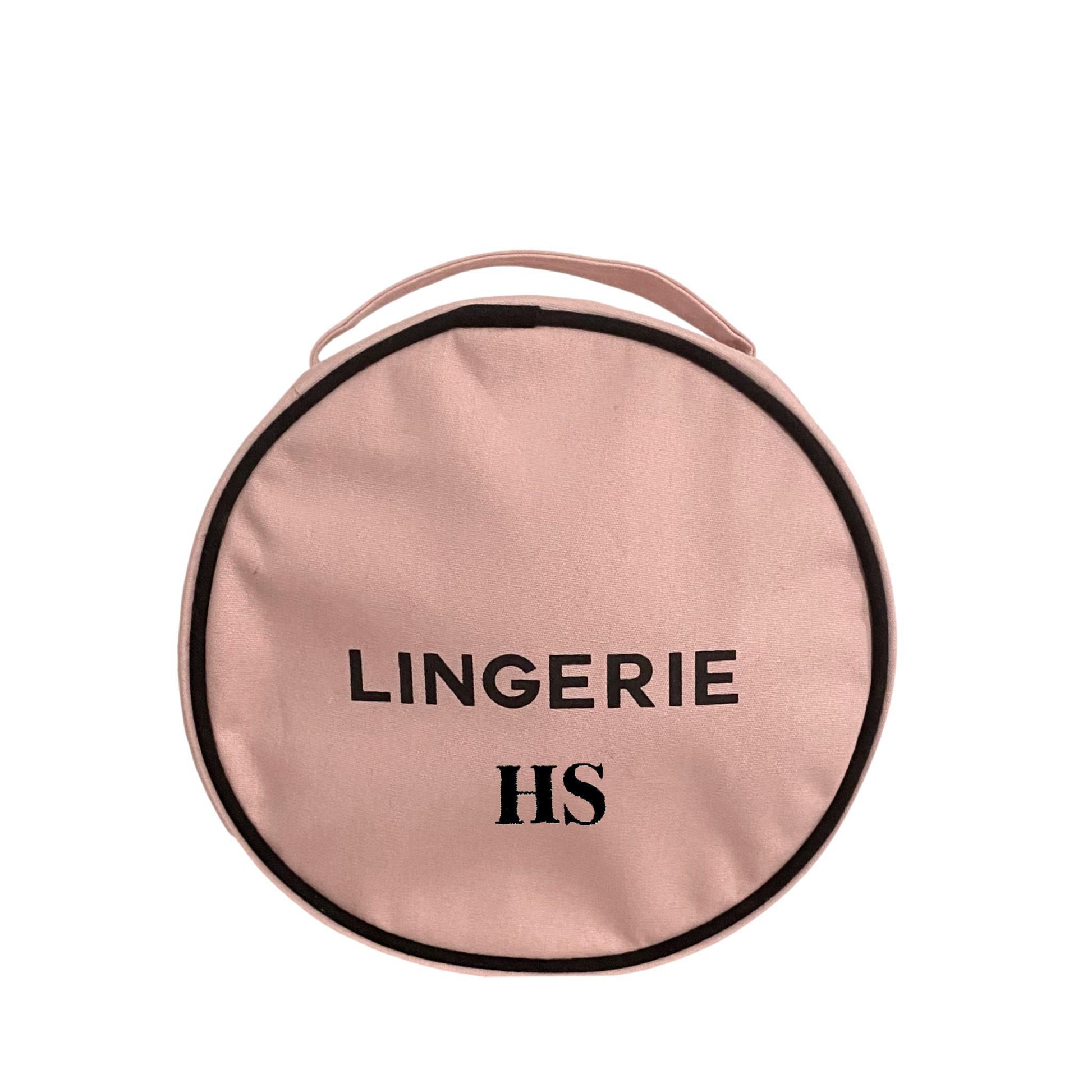 Bag-all Round Lingerie Case in blush pink cotton with black trim and text, featuring metal zipper and custom black and white interior lining